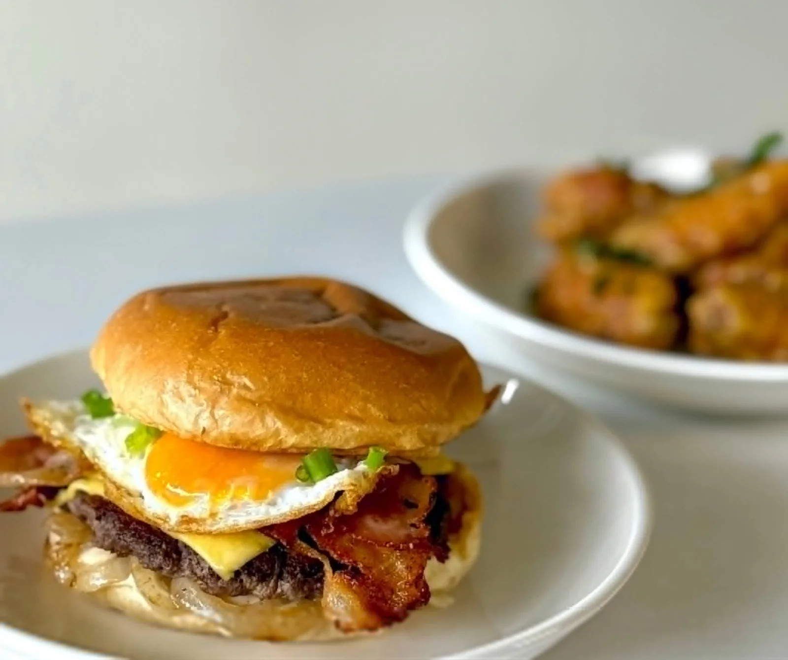 Burger layered with cheese, bacon and a fried egg